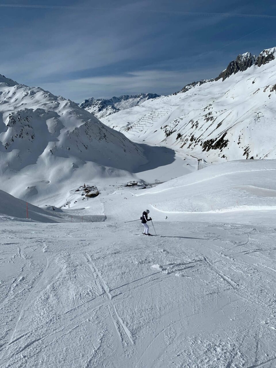 Snøkledd alpinbakke med utsikt til fjell