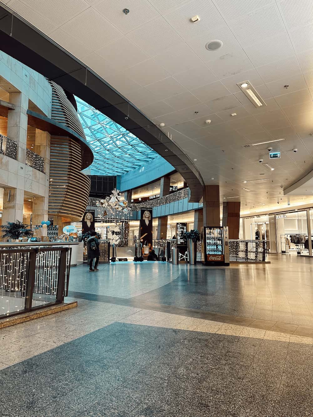 Kjøpesenter med julelys og butikker. Foto