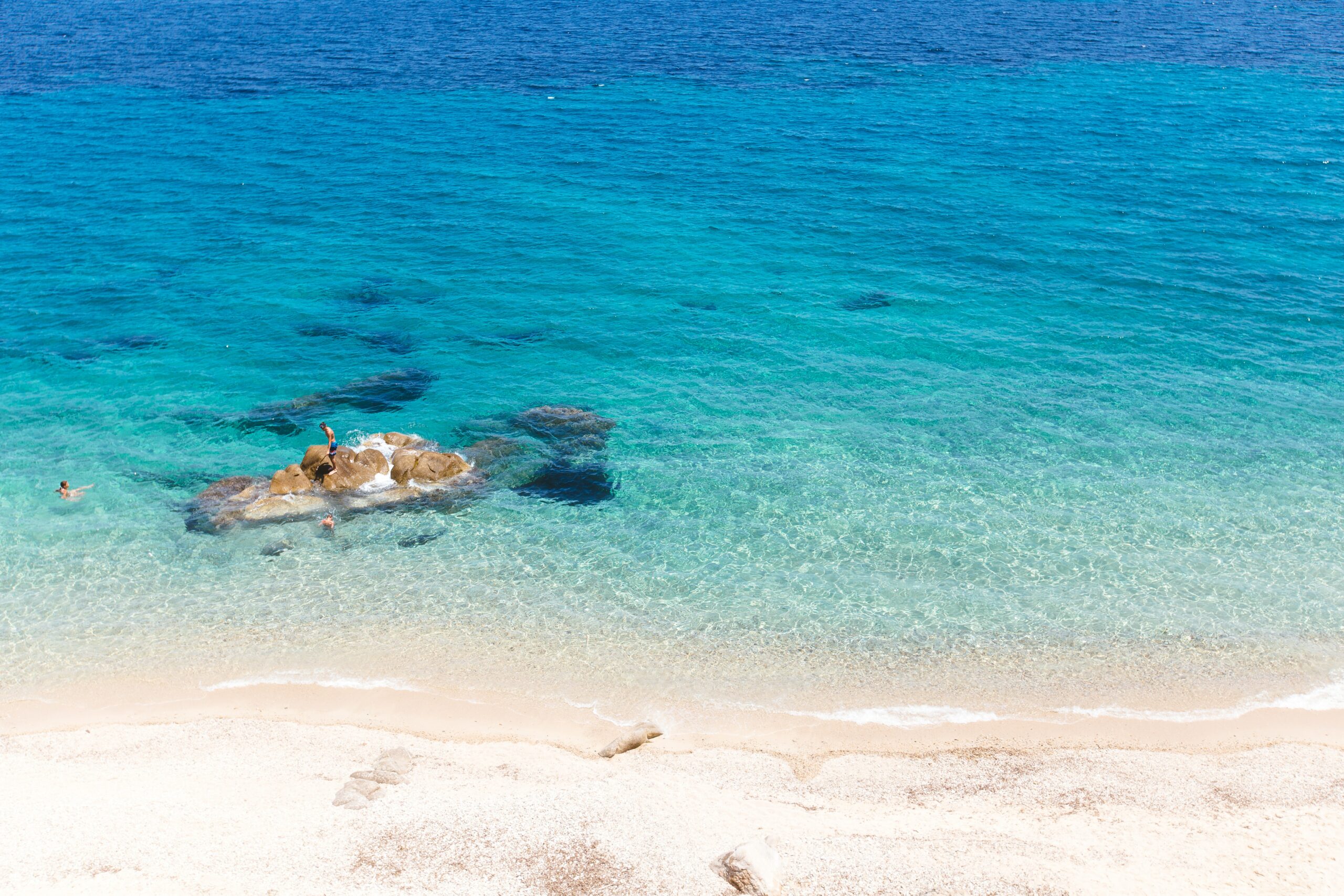 Kritthvit strand og azurblått hav. Foto