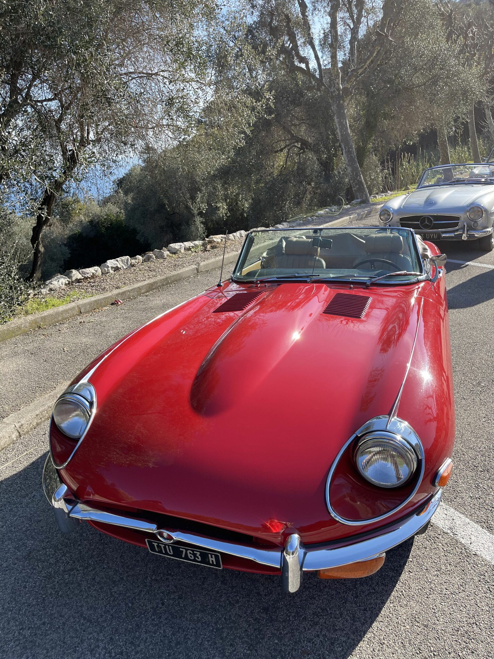 En klassisk, gammel rød bil som står parkert. Foto